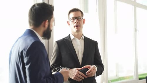 Two Business Partners Talking in Office