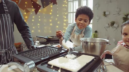 Children Making Waffles Together in Kitchen