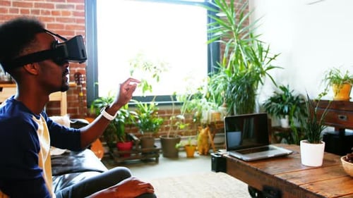 Young Man Experiencing Virtual Reality With Headset