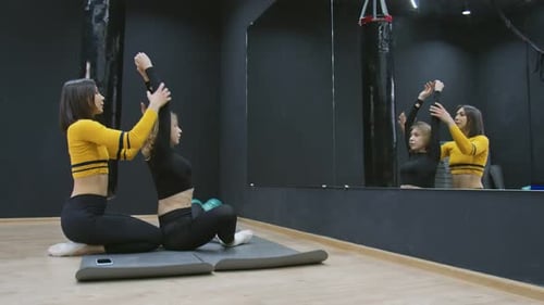 Women Stretching Together in a Fitness Studio