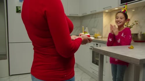 Family Celebrates Birthday with Cake and Joyful Moments