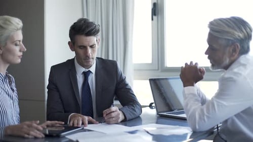Business people signing document in office