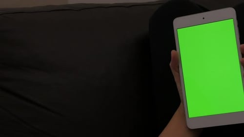 Holding green screen PC tablet at home chroma key tablet 4K 2160p 30fps UltraHD footage - Young fema