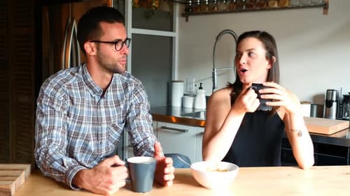Couple Having Coffee and Cereal in Kitchen