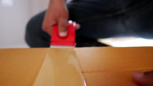 Taping a Cardboard Box with Tape Gun