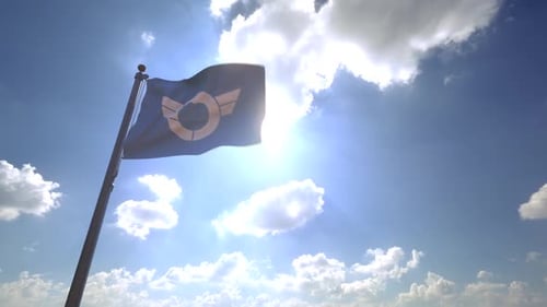 Realistic Flag Waving with Corporate Logo Against Blue Sky