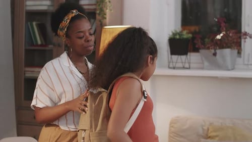 Caring Mom Getting Daughter Ready For School