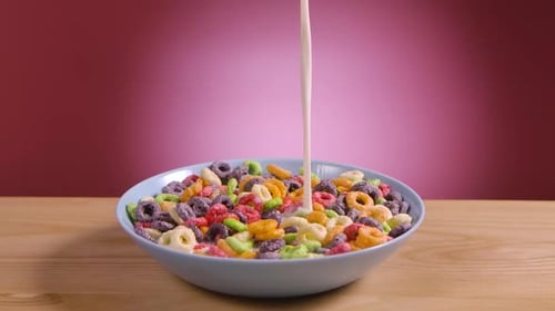 Milk Pouring into Colorful Loop Cereal Bowl