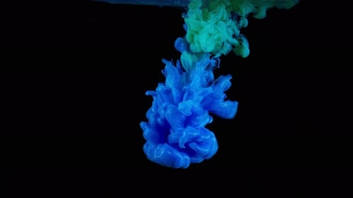 Blue and green inks spreading in water