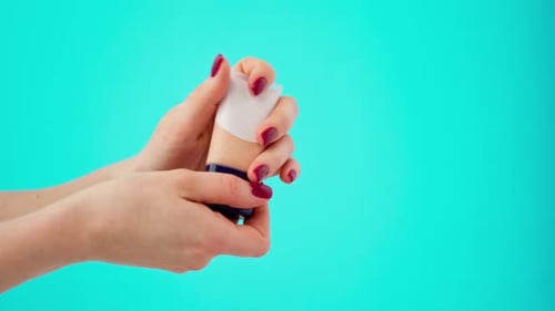 Hands Apply Foundation from Tube, Close Up