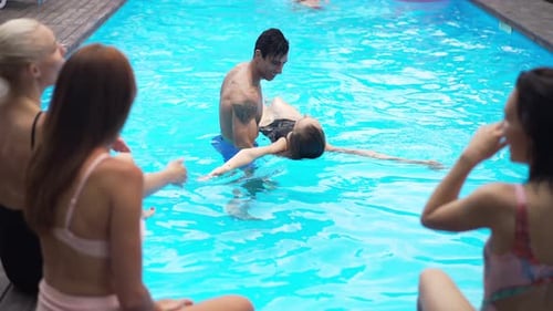 Friends Relaxing and Swimming at an Outdoor Pool