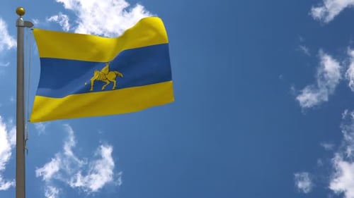 Waving Flag with Golden Knight on Horse Emblem against Blue Sky