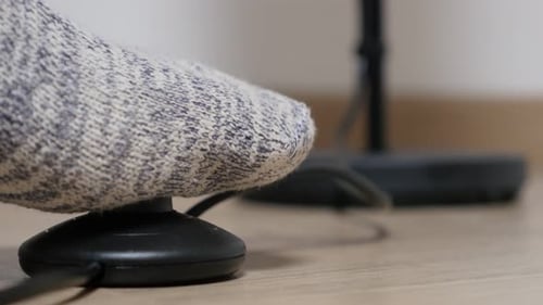 Modern stand lamp foot switching on and off close-up on button 4K 2160p 30fps UHD footage - Stepping