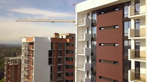 Aerial view of high residential apartment buildings under construction. Real estate development.