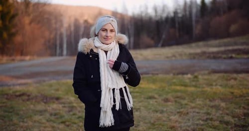 Stylish Woman Posing in Autumnal Landscape