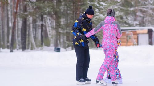 Family with Little Daughter Skates Walking Around on Rink