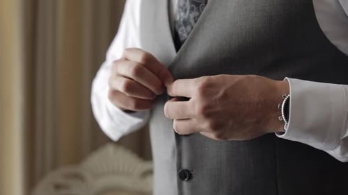 Buttoning Jacket with Hands Close Up Man in Suit Fastens Buttons on His Jacket Preparing To Go Out