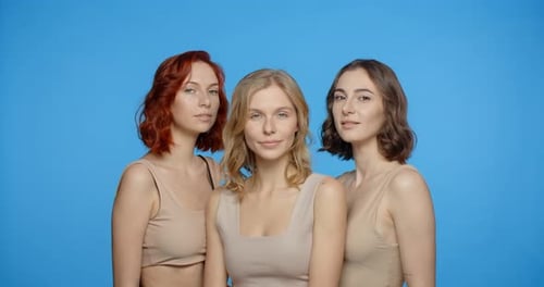 Three Young Women Posing in Studio Together