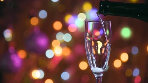 Champagne Being Poured in Festive Bokeh Setting