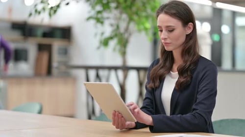 Young Woman Working with Tablet at Bright Desk