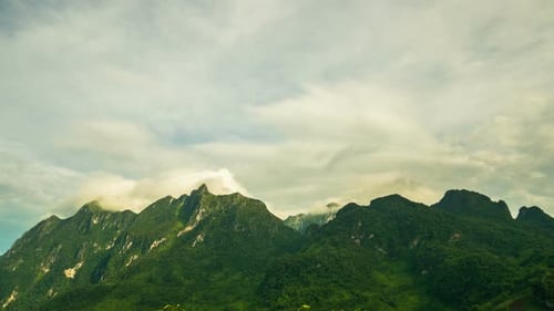 Lush Green Mountain Peaks with Time Lapse Clouds