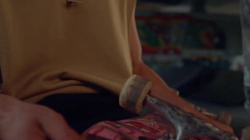 Skateboarder Holding Skate Board in Hands at City