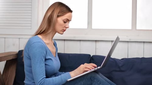 Woman Working on Laptop Indoors at Home