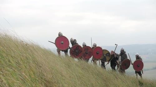 Medieval Soldiers Marching Up Grassy Hill