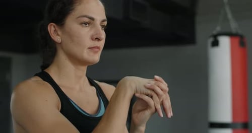 Steadicam Shot Woman Makes Warm Up Before Exercising in the Gym Athlete Stretches Hands 120 Fps
