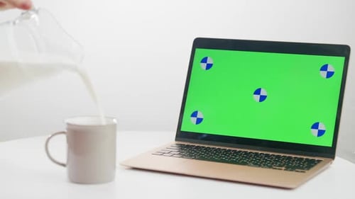 Milk Being Poured Next to Laptop with Green Screen