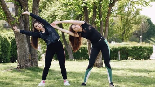 Young Women Exercising in an Urban Park