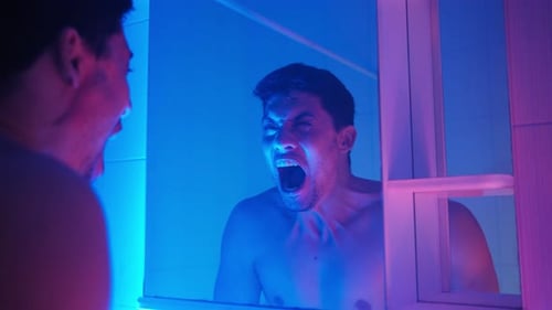Distressed Man Yelling in a Blue and Pink Bathroom