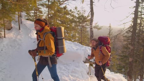 Couple Hiking in Snowy Winter Mountain Forest