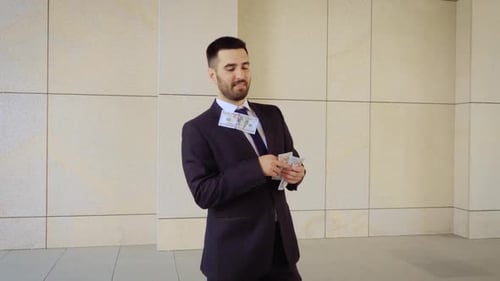 Lucky Caucasian Businessman Is Celebrating His Victorious Achievement By Dancing in Money Rain in