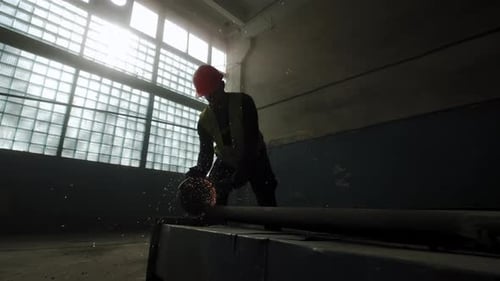 Construction Worker Cutting Metal with Chop Saw