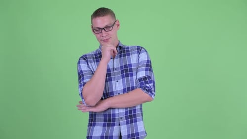 Thoughtful Young Adult Man with Plaid Shirt