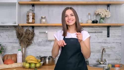 Smiling Woman Preparing Fresh Vegetables in Kitchen