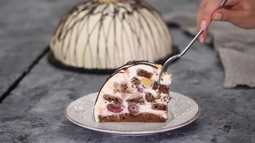 Taking Bite of Cake with Cherries and Cream