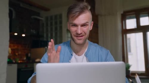 Man Chatting with Laptop at Home