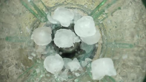 Ice Cubes Fall into Glass Blender for Beverage