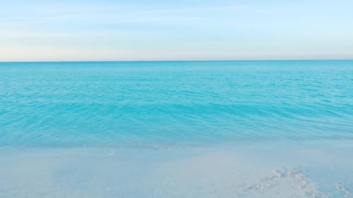 Moving Towards The Ocean Across A Caribbean Beach At Dusk
