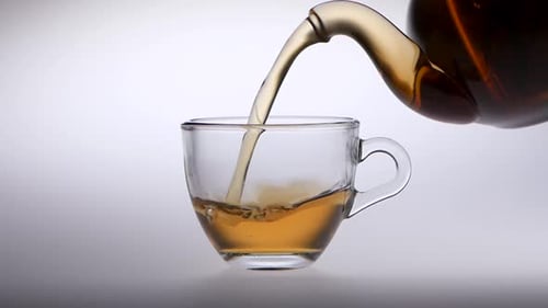 Tea Pouring into Glass Cup