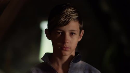 Boy's face in dim light close up