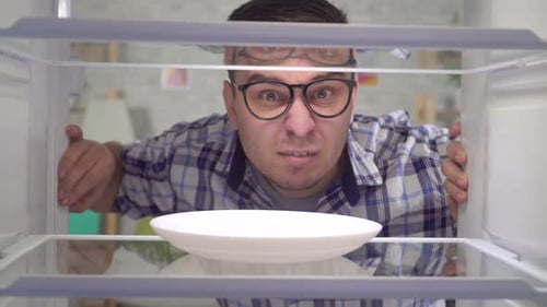 Man Disappointed by Empty Refrigerator, Empty Plate