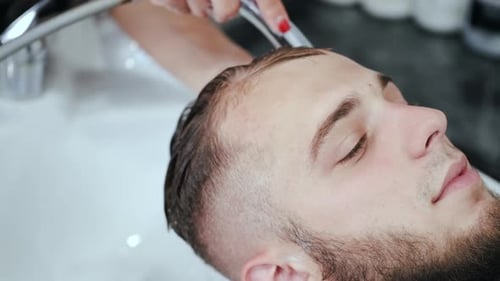 Man Getting His Hair Washed at Salon