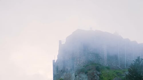 Old Orthodox Monastery on Mountain Peak. Misty Stone Building Standing on Hill