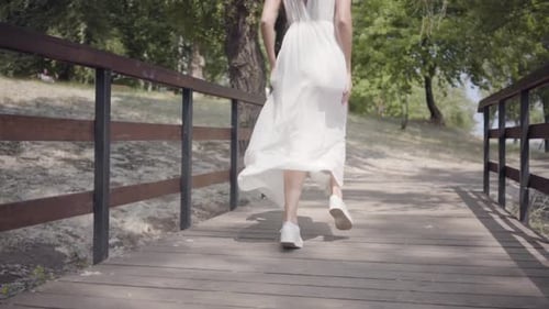 Portrait Cute Young Girl with Brunette Hair Wearing Sunglasses and Long White Summer Fashion Dress