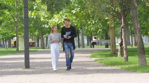 Couple of Students in Love Walking Along Together on Campus