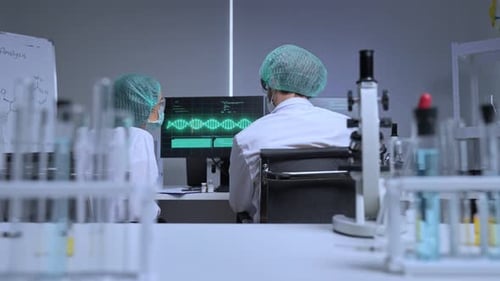 Scientists Analyzing DNA Sequence in Medical Laboratory