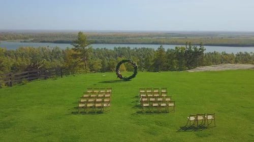 Wedding Venue and Chairs on Field on Sunny Day Upper View